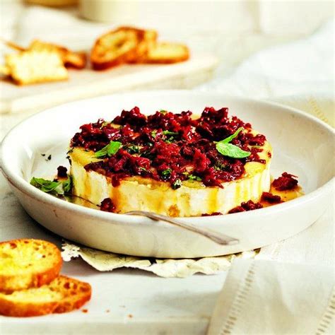 baked-brie-with-sun-dried-tomatoes-and-basil-chatelaine image