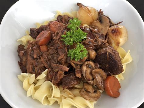 homemade-beef-bourguignon-over-egg-noodles-food image