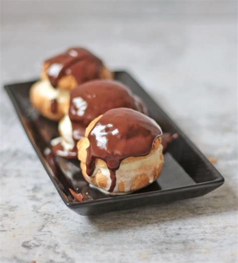 classic-french-profiteroles-with-chocolate-sauce-a-baking-journey image
