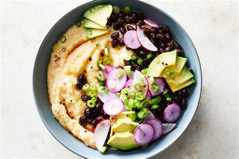 cheese-grits-with-saucy-black-beans-avocado-and-radish image
