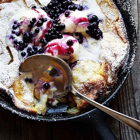 peach-dutch-baby-with-blueberry-sauce-seasons-and-suppers image
