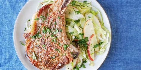 seared-pork-chops-with-apple-cabbage-slaw-delish image