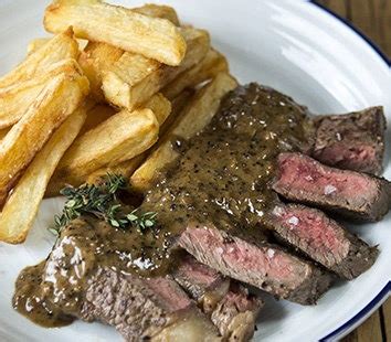 ribeye-steak-and-peppercorn-sauce-with-chips image