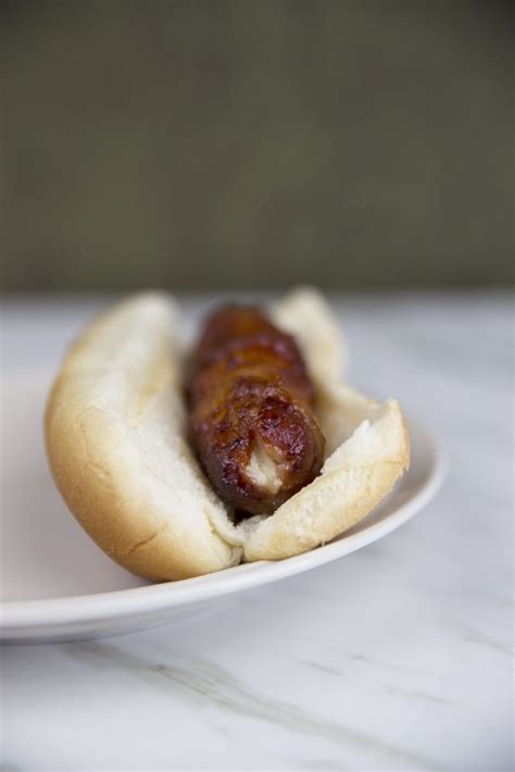 bacon-wrapped-cheese-stuffed-bbq-hot-dogs image