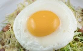 frise-salad-with-lardons-and-poached-eggs-recipe-epicurious image