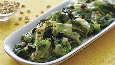 sauted-escarole-with-raisins-pine-nuts-and-capers image
