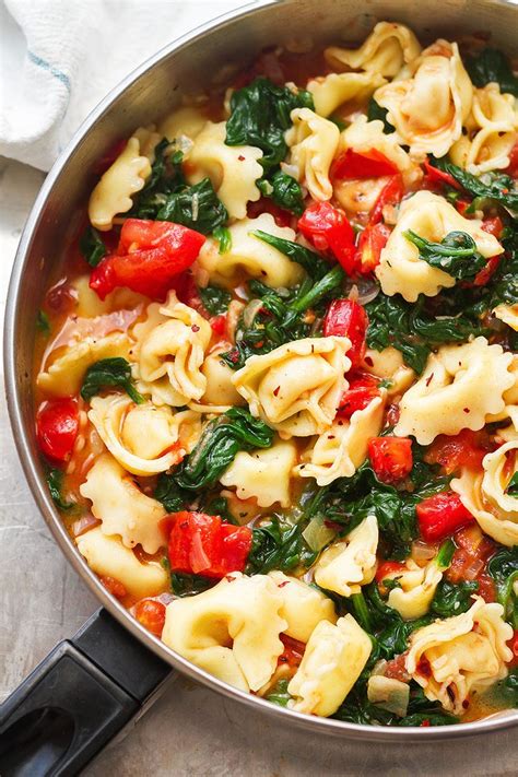 tortellini-pasta-in-garlic-spinach-tomato-sauce-eatwell101 image