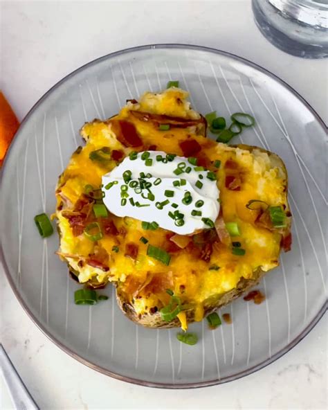 loaded-baked-potato-recipe-with-lots-of-cheese-bacon image