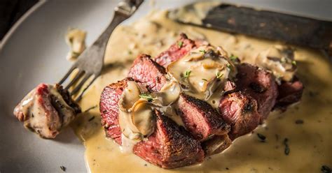 grilled-peppercorn-steaks-with-mushroom-cream-sauce-traeger image