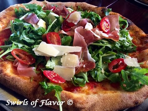 grilled-arugula-salad-pizza-with-prosciutto-swirls-of image