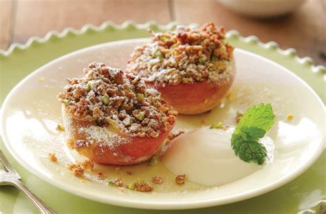 grilled-peaches-with-berry-sauce-and-pistachio image