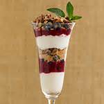 crunchy-tropical-berry-and-almond-breakfast-parfait image