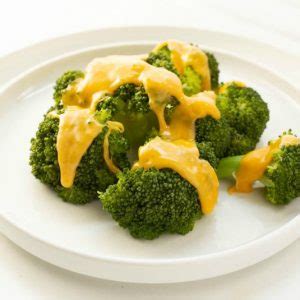 steamed-broccoli-with-cheddar-cheese-sauce-the image
