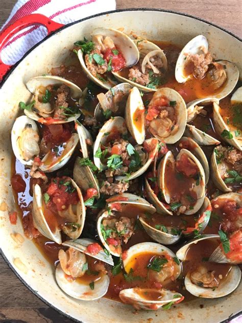 clams-with-spicy-sausage-in-garlicky-tomato-broth image