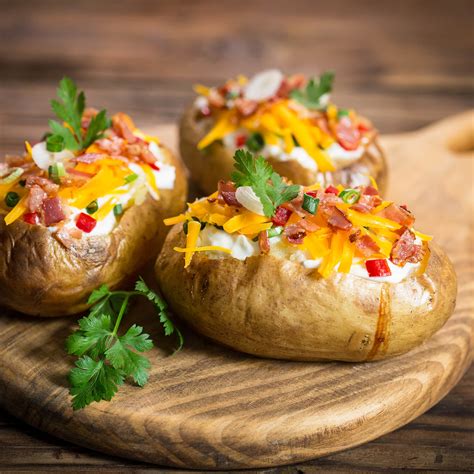baked-potatoes-with-bacon-cheddar-and-chives image
