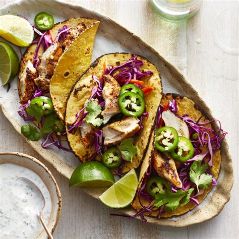 grilled-chicken-tacos-with-slaw-lime-crema-eatingwell image