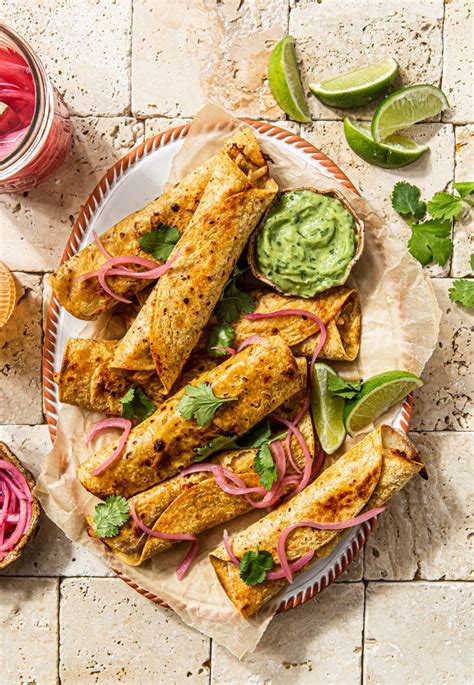 baked-spicy-chicken-taquitos-with-avocado-cilantro-dip image