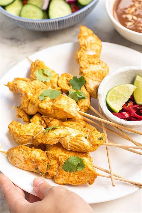 spicy-peanut-chicken-satay-with-cucumber-salad-foodal image