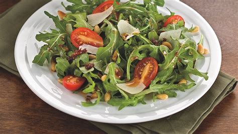 arugula-salad-with-sun-dried-tomato-vinaigrette image