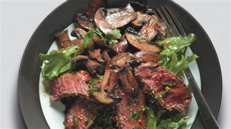 seared-asian-steak-and-mushrooms-on-mixed-greens image