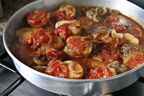 kafta-patties-topped-with-potatoes-and-tomatoes image