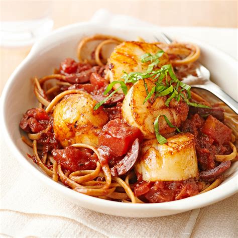 pan-seared-scallops-with-tomato-olives-and-fresh-basil image