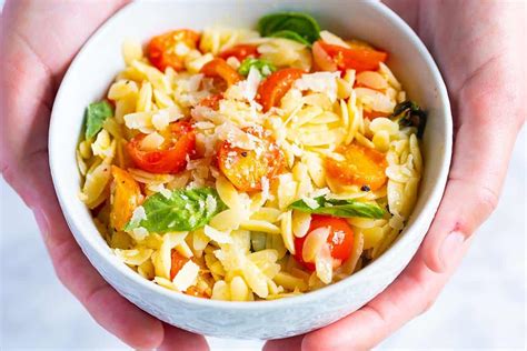 orzo-pasta-with-tomatoes-basil-and-parmesan-inspired-taste image