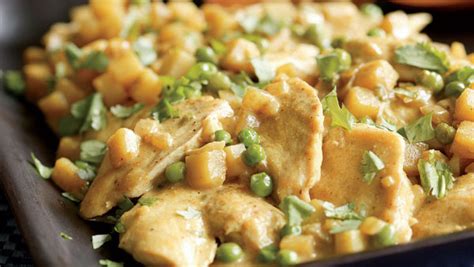 chicken-with-potatoes-peas-coconut-curry-sauce image