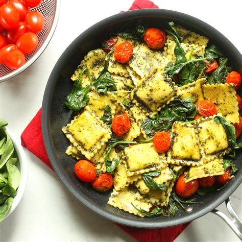 pesto-ravioli-with-spinach-tomatoes-eatingwell image