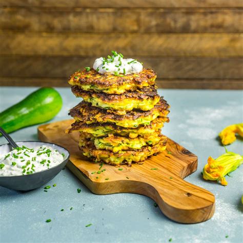 cheesy-zucchini-and-corn-fritters-with-herb-sour-cream image
