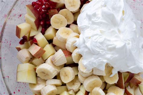 pomegranate-salad-with-bananas-apples-and-sweet-whipped image
