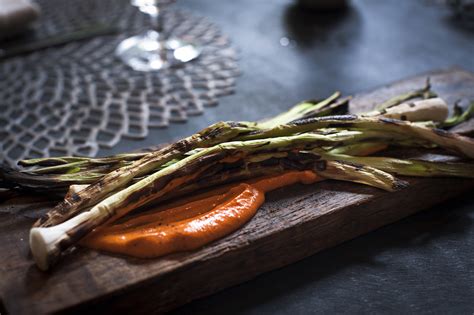 grilled-scallions-with-romesco-sauce-food-republic image