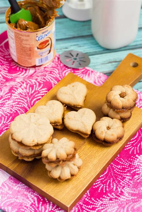 cinnamon-dulce-de-leche-spritz-sandwich-cookies image