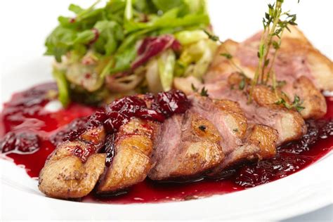 seared-duck-with-cherry-red-wine-reduction-sauce image