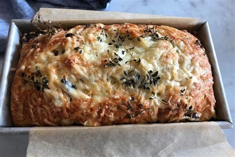 a-savory-loaf-packed-with-cheese-and-olives-the image