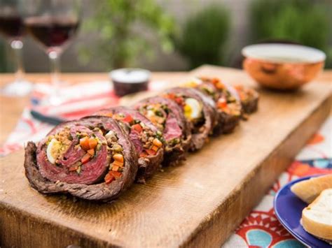 rolled-stuffed-flank-steak-with-garlicky-herb-sauce image