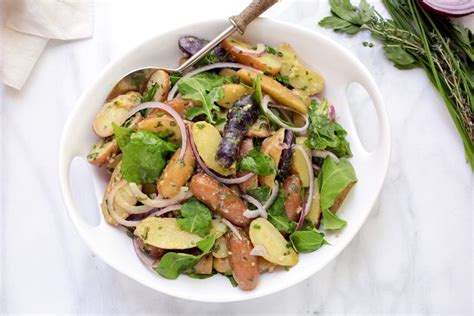 french-potato-salad-with-baby-arugula-striped-spatula image