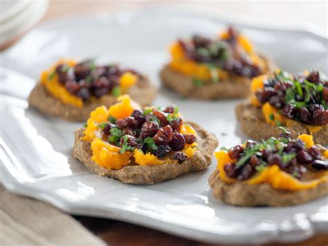 butternut-squash-and-pecan-blini-with-currant-caviar image