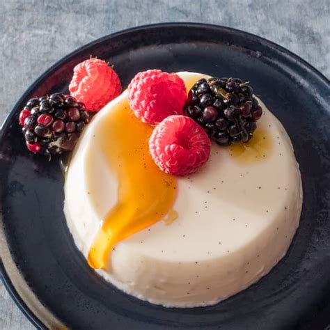 buttermilk-vanilla-panna-cotta-with-berries-and-honey image
