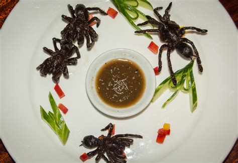 edible-spiders-eating-deep-fried-tarantula-in-cambodia image