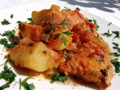 cod-in-tomato-sauce-with-potatoes-cooking-in-plain image
