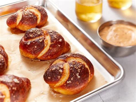 soft-pretzel-knots-with-beer-cheese-recipe-food-network image