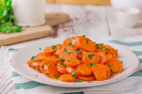 simple-steamed-carrots-with-butter-recipe-the-spruce image