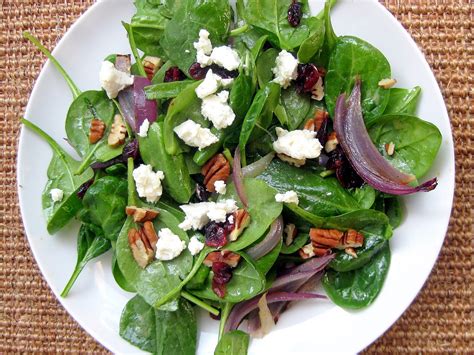 spinach-salad-with-bosc-pears-cranberries-red-onion image