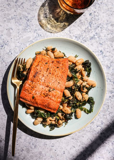 easy-broiled-salmon-over-herby-white-beans-and-kale image