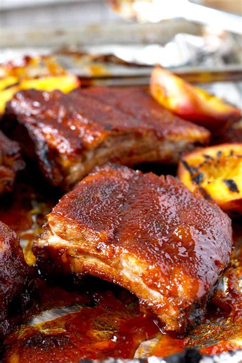 baked-pork-ribs-with-bourbon-peach-bbq-sauce-lemon image