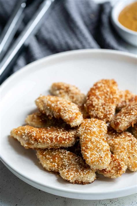 crispy-sesame-chicken-fingers-with-spicy-peanut-sauce image