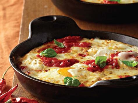 baked-eggs-with-ricotta-mozzarella-and-spicy-tomato image