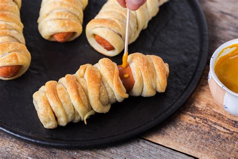 mummy-hot-dogs-recipe-for-halloween-the-spruce image