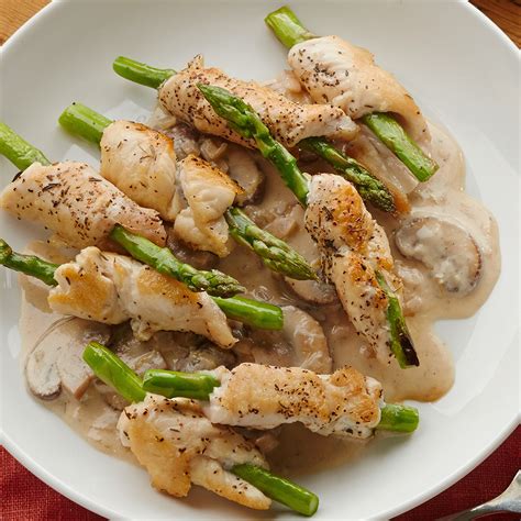 chicken-and-asparagus-rolls-with-garlic-cream-sauce image